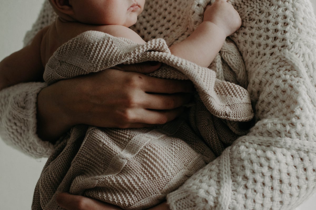 Woman Carrying A Baby 